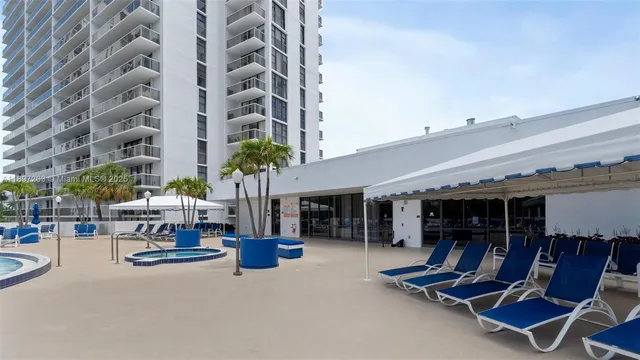 a view of outdoor kitchen with swimming pool and sitting area