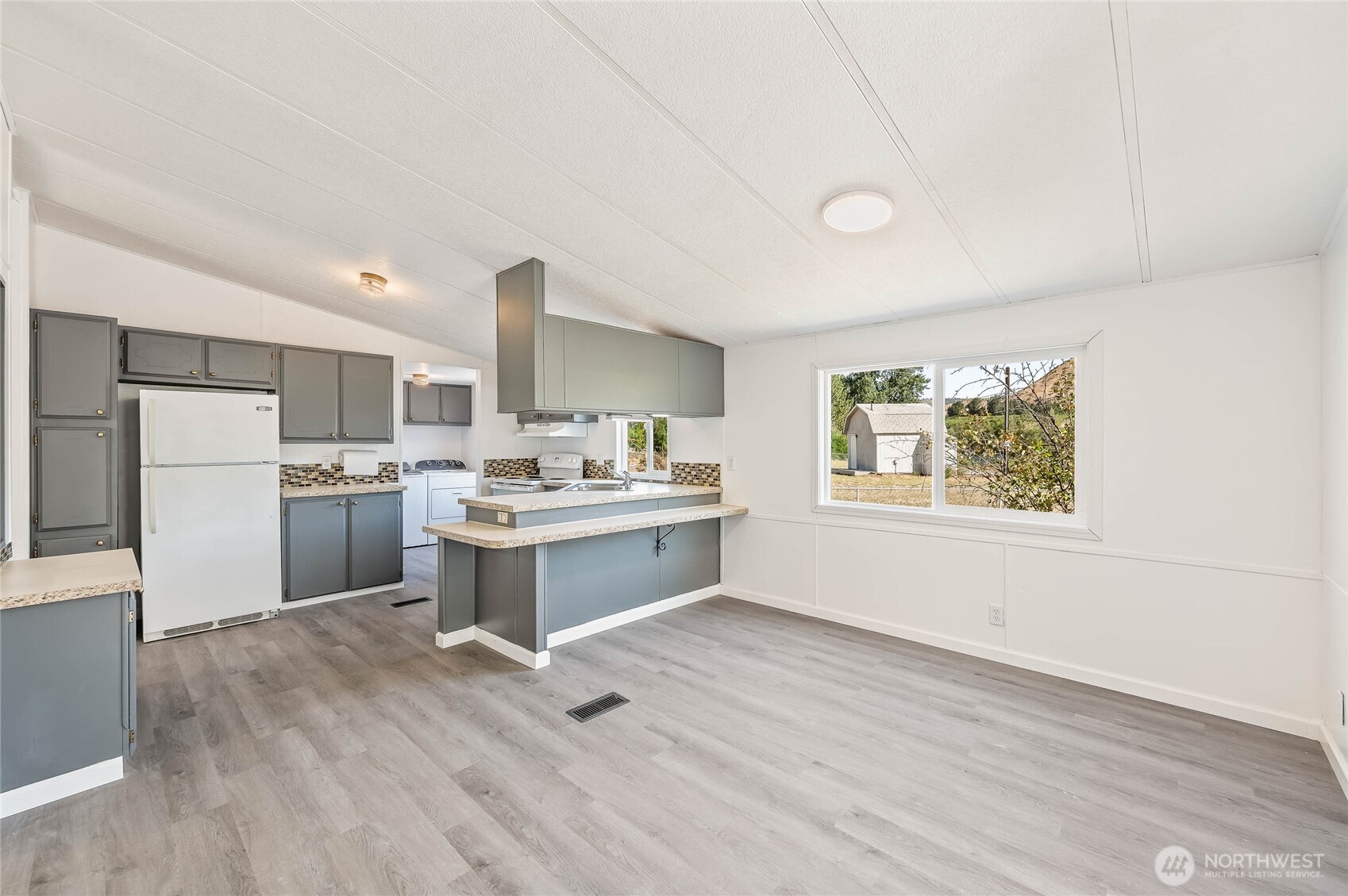 138 Trestle View Lane Cashmere, WA 98815 - Photo 6 of 30 a open kitchen with kitchen island white cabinets and stainless steel appliances