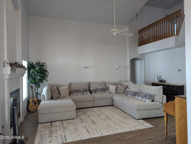a living room with furniture and a potted plant