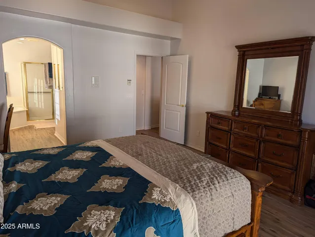 a bedroom with a bed and a dresser in it