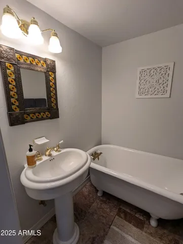 a bathroom with a sink a mirror and a toilet