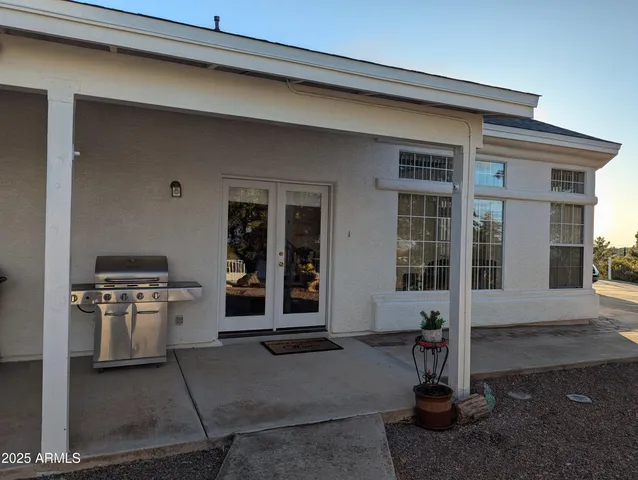 a view of a house with backyard and sitting area