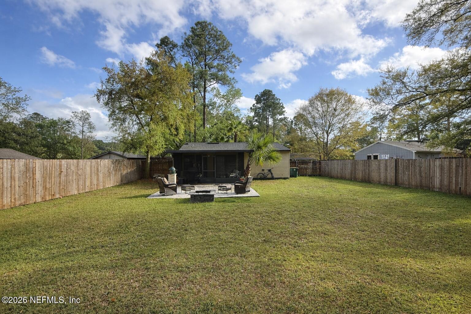 3173 Ricky Drive Jacksonville, FL 32223 - Photo 12 of 12 a view of a backyard with couches and a large tree