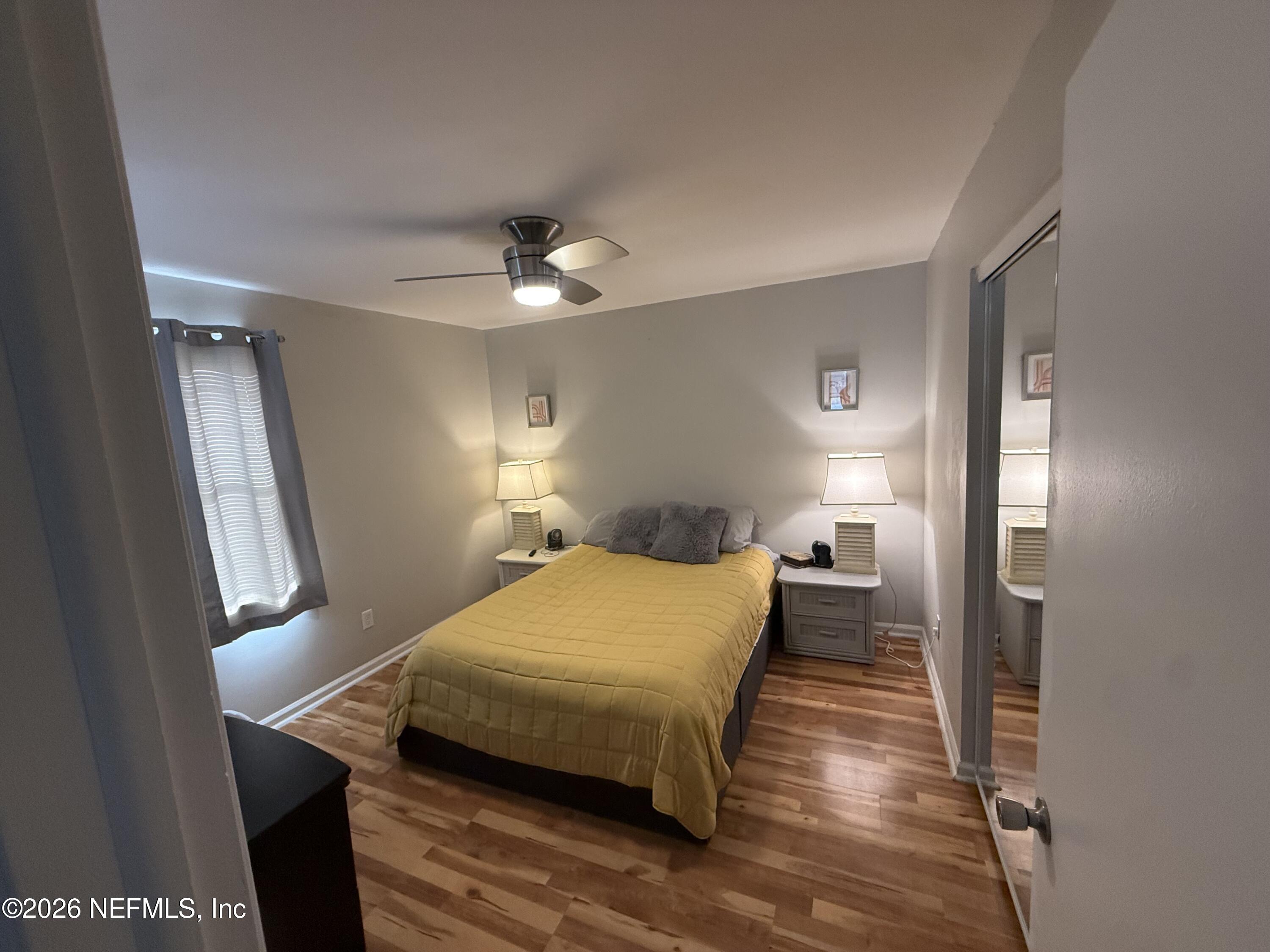 3173 Ricky Drive Jacksonville, FL 32223 - Photo 5 of 12 a bedroom with a bed and a chandelier