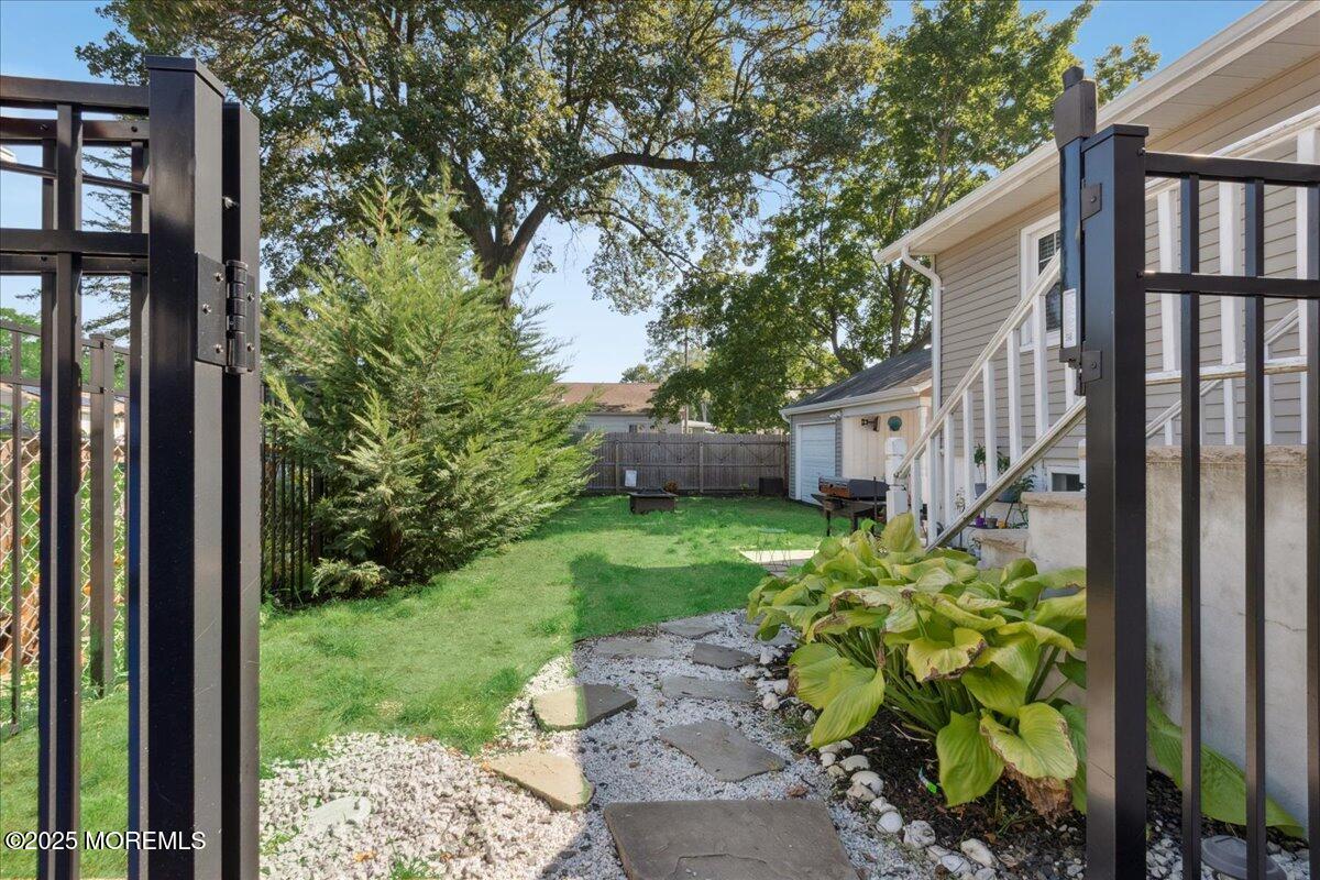 77 Drift Road Belford, NJ 07718 - Photo 20 of 23 a view of a garden with a house in the background
