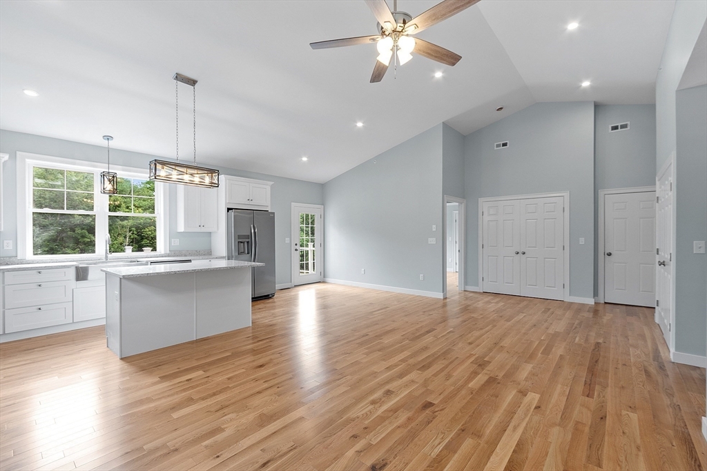 94 Fitchburg Road, Unit 2 Townsend, MA 01469 - Photo 11 of 31 an empty room with wooden floor and windows