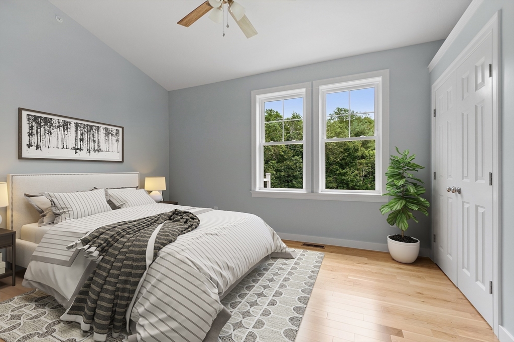 94 Fitchburg Road, Unit 2 Townsend, MA 01469 - Photo 12 of 31 a bedroom with a large bed and a potted plant