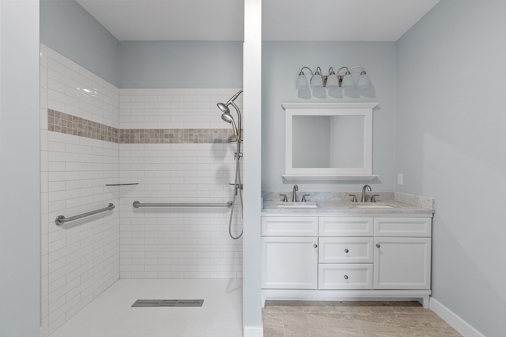 94 Fitchburg Road, Unit 2 Townsend, MA 01469 - Photo 15 of 31 a bathroom with a shower sink and mirror