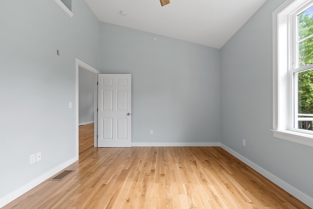 94 Fitchburg Road, Unit 2 Townsend, MA 01469 - Photo 17 of 31 an empty room with wooden floor and windows