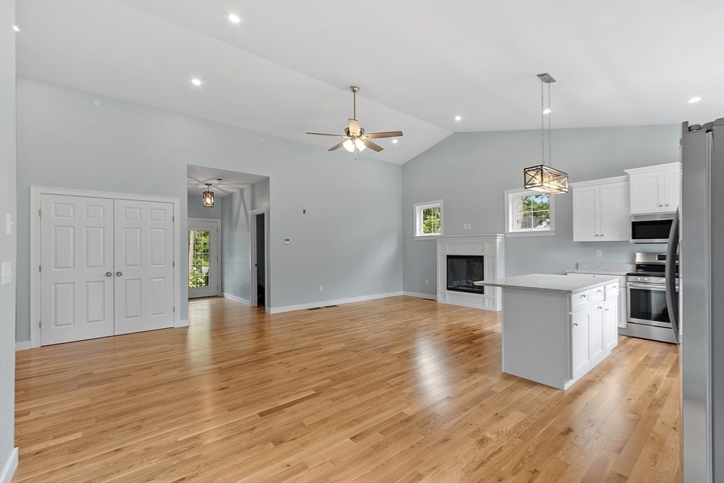94 Fitchburg Road, Unit 2 Townsend, MA 01469 - Photo 5 of 31 a view of a kitchen with a stove cabinets and wooden floor