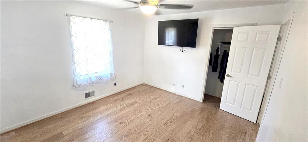 4034 Weeks Drive Kennesaw, GA 30144 - Photo 15 of 24 an empty room with windows and fan