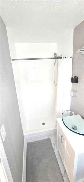 4034 Weeks Drive Kennesaw, GA 30144 - Photo 20 of 24 a bathroom with a sink and a shower