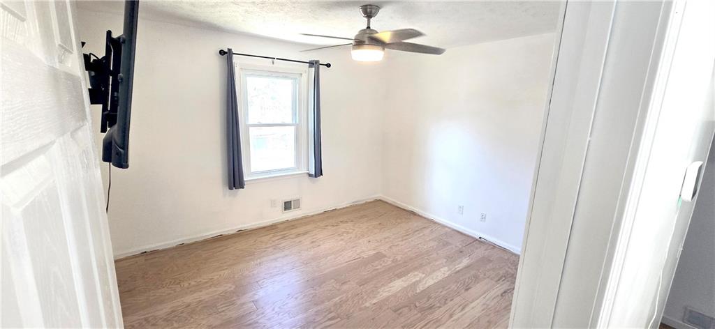 4034 Weeks Drive Kennesaw, GA 30144 - Photo 21 of 24 an empty room with windows and fan