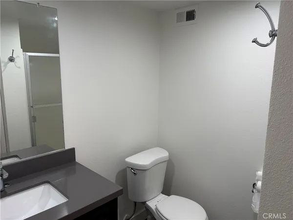 a white toilet sitting next to a bathroom sink