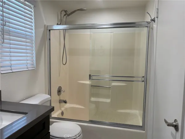 a bathroom with a shower a toilet and a sink