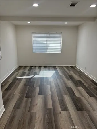 a view of an empty room and wooden floor