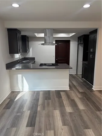 a view of a kitchen with a sink and a large mirror in a room