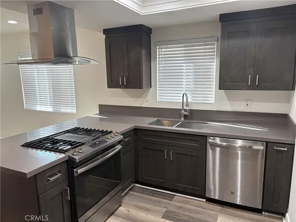 a kitchen with granite countertop a stove sink and cabinets