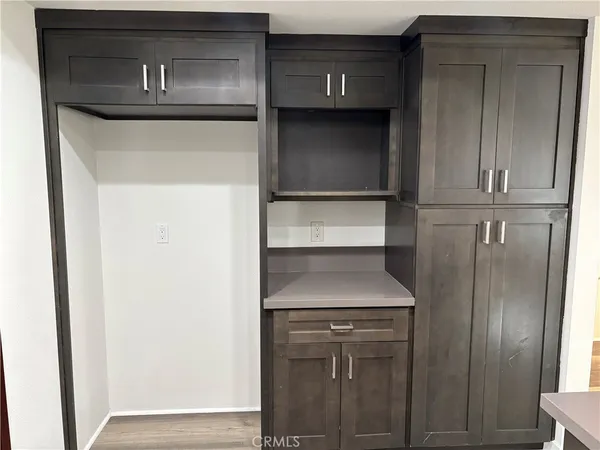 a kitchen with a refrigerator and cabinets