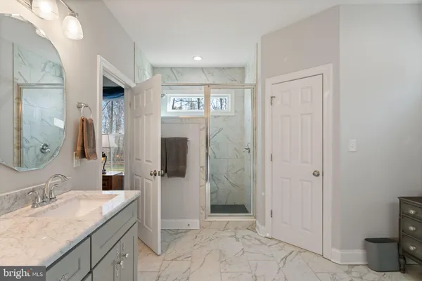 a spacious bathroom with a double vanity sink and a mirror
