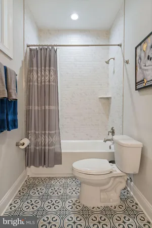 a en suite bathroom with a granite countertop sink and a mirror