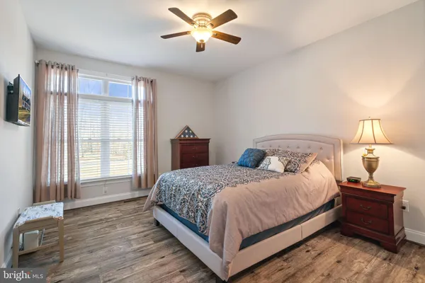 a large bed sitting in a bedroom next to a window