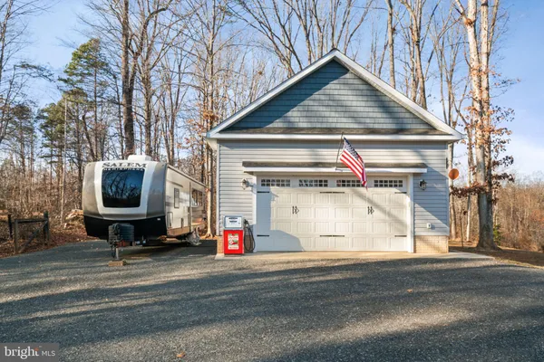 a view of the house and car parked on the road