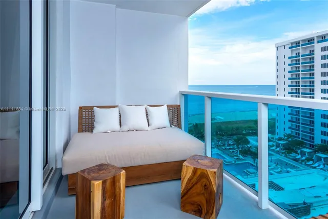 a bedroom with a bed and balcony view
