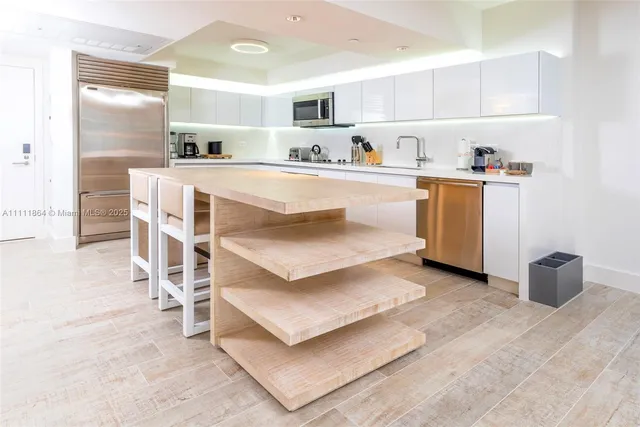 a kitchen with a sink cabinets and window