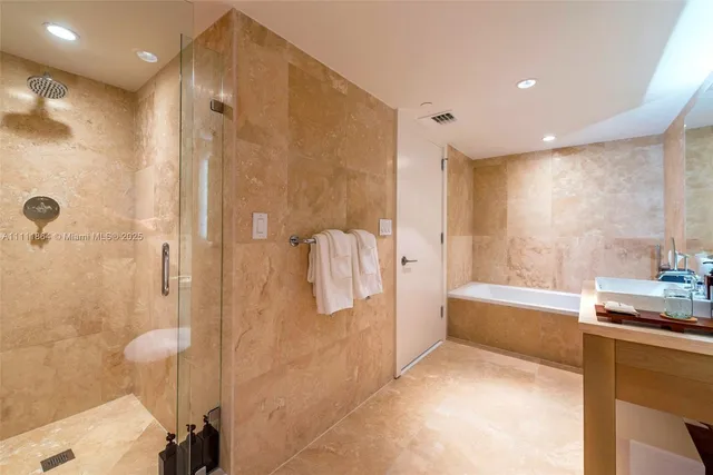a bathroom with a bathtub and a shower