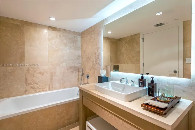 a bath room with a sink and a bath tub