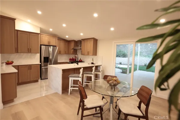 a kitchen with kitchen island a appliances dining table and chairs