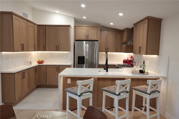 a dining room with furniture and a kitchen view