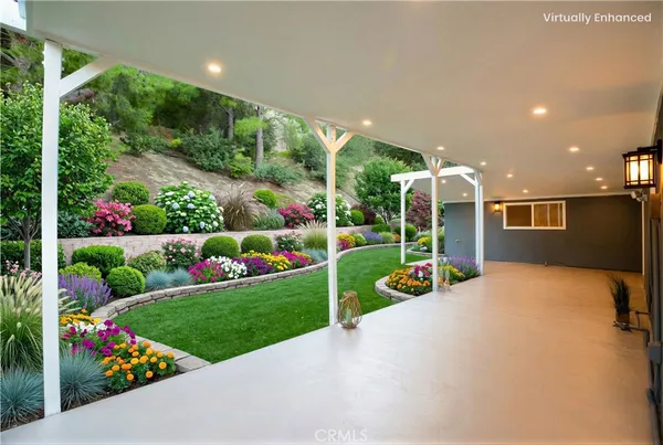 a view of garden with flowers and trees