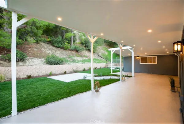 a view of a house with backyard and porch