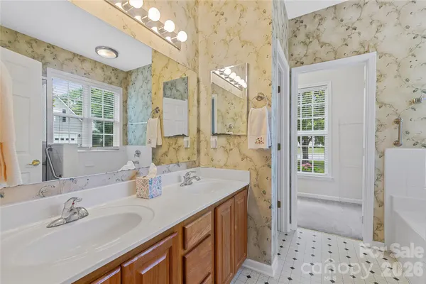 a bathroom with a sink double vanity and a shower