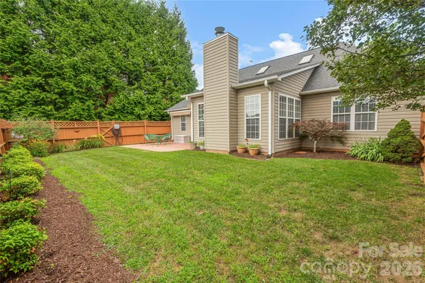 a front view of a house with backyard and garden