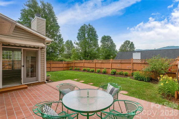 a view of a backyard with plants and porch