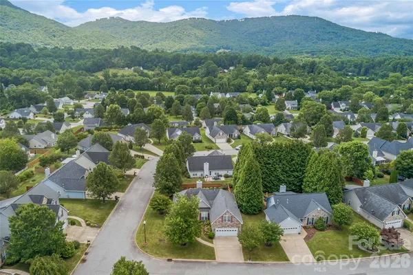 an aerial view of residential houses with outdoor space and street view
