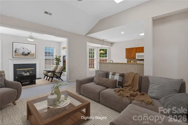 a living room with furniture a fireplace and a table