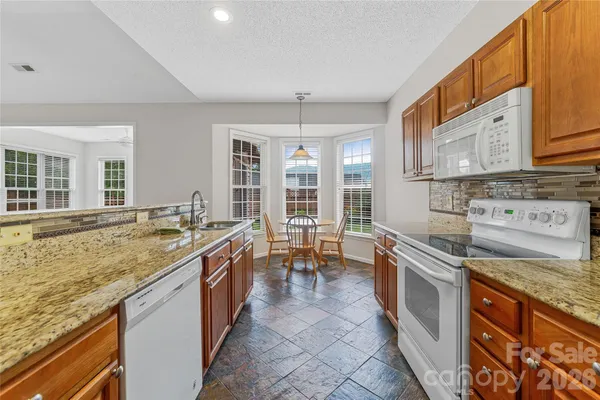 a kitchen with sink stove and cabinets