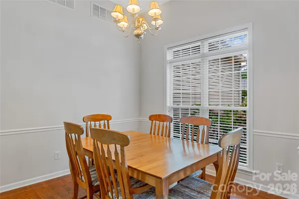 a view of a dining room with furniture wooden floor and a chandelier
