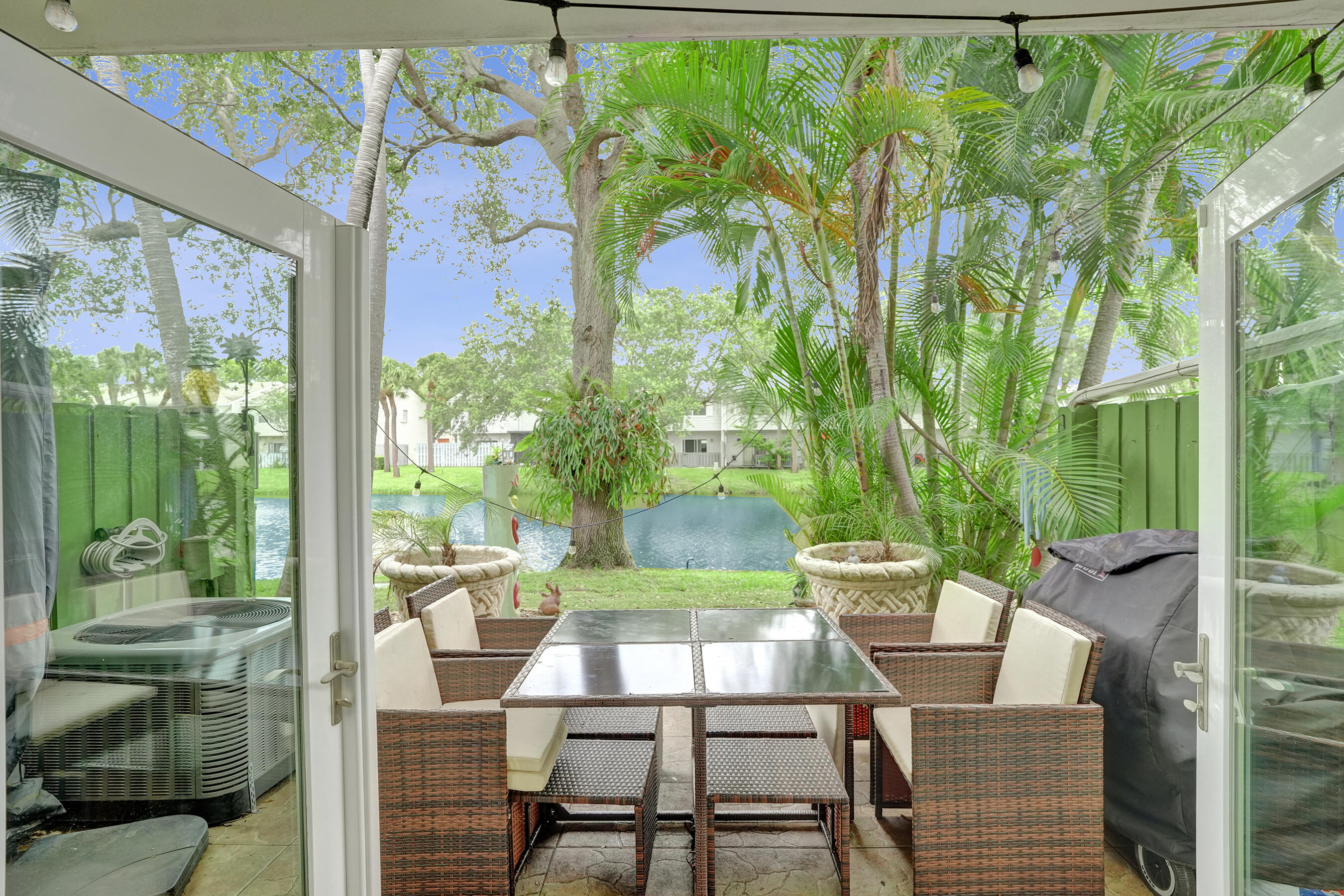147 Southwest 3rd Street Pompano Beach, FL 33060 - Photo 1 of 29 a view of a patio with table and chairs and potted plants
