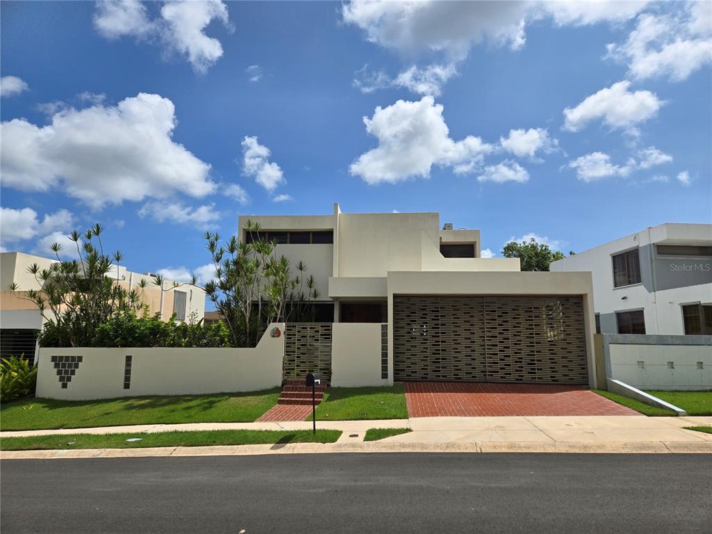 10 Isabel La Guaynabo, PR 00969 - Photo 1 of 1 a front view of a house with a yard and garage