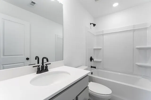 a roof deck with table and chairs potted plants