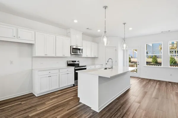 a view of kitchen and kitchen island wooden floor