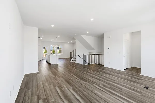 a view of kitchen with wooden floor and electronic appliances