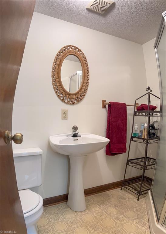 1697 Beasley School Road Sandy Ridge, NC 27046 - Photo 12 of 26 Full bath just off kitchen hallway to garage