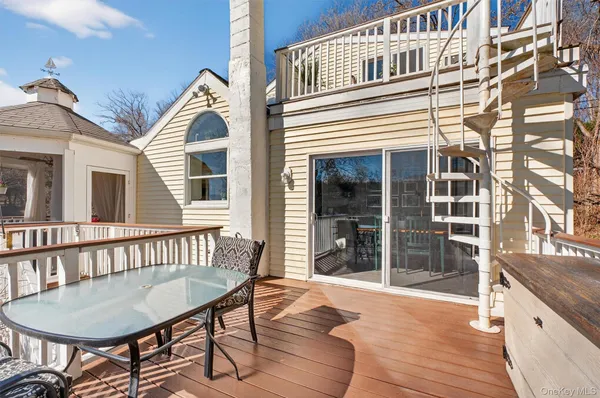 a view of a house with a wooden deck