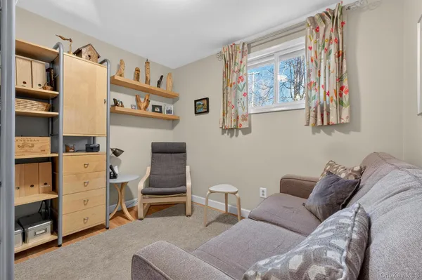 a living room with furniture and cabinets
